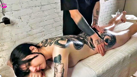Tattooed nude babe with massive octopus back tattoo gets sensual ass massage on table