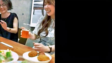 Two Asian women in casual outfits smiling over drinks and appetizers in erotic JAV meeting scene
