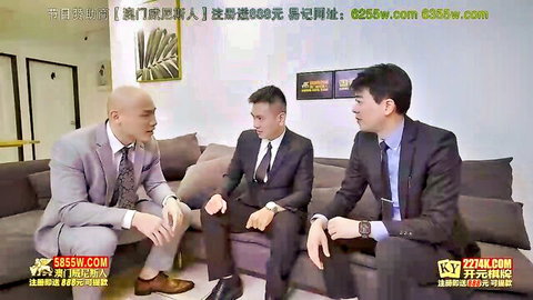 Three suited Asian men in formal interview discussion