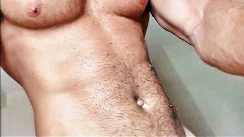 Hairy muscular man flexing ripped chest abs and treasure trail