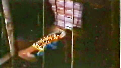 Vintage 1976 porn scene: nude woman in sex sling pose, classic erotic display