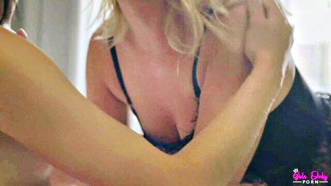 Blonde Casey in black lingerie intimately touching partner's breasts