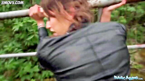 Brunette in black leather jacket bent over public rail for outdoor sex