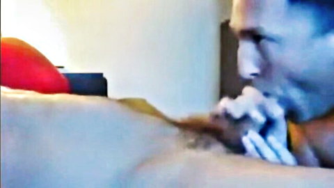 Hairy man's thick cock gripped in handjob with cum dripping on bed