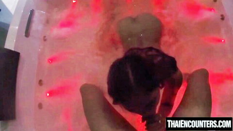 Asian GF's curvy ass up in red-lit jacuzzi during steamy vacation sex