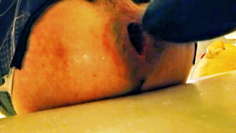 Bearded man deepthroating massive black dildo with stretched lips in amateur closeup