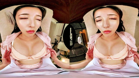 Asian woman in pink lingerie exposing breasts in seductive VR pose