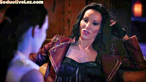 Seductive brunette in leather jacket and lingerie seduces pale lesbian babe with intense eye contact foreplay