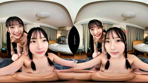 Nude Asian pigtail babes smile while one spreads legs wide exposing shaved pussy in VR bedroom