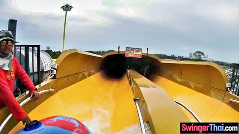 Big bum Asian GF rides yellow water slide at park, wet fun outdoor
