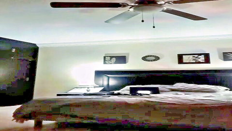 Empty hotel bedroom with rumpled bed sheets and ceiling fan for amateur fucking
