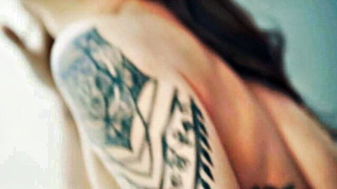 Tattooed woman with dark hair in sensual pose, big tits threesome tease