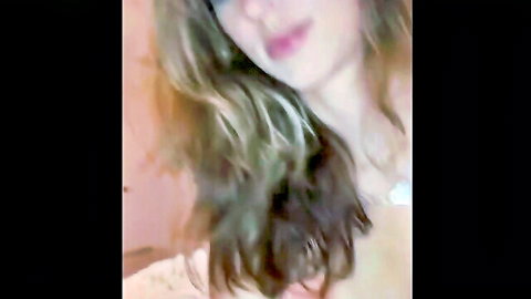 Blonde webcam girl teases with cleavage in sheer white top closeup
