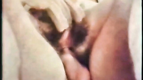 Vintage close-up of woman's hairy wet pussy with pink labia spread wide