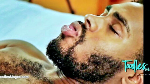 Ecstatic bearded ebony hunk lies back eyes closed tongue out during blowjob pleasure