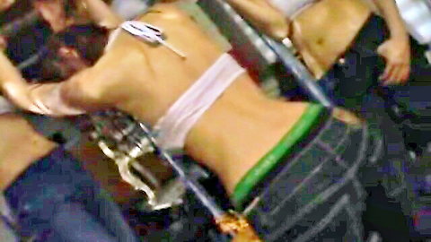 Asian women in white bikini tops and low-rise jeans in intense catfight