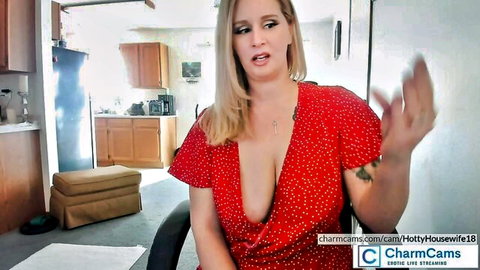 Blonde camgirl in sexy red dress showing cleavage in interactive chat