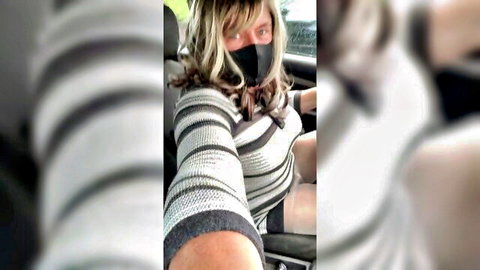 Mature blonde with huge tits teases deep cleavage in striped sweater and mask car selfie