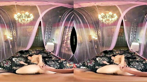 Asian babe spreads legs wide exposing shaved pussy touching herself on luxurious pink canopy bed