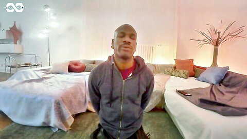 Muscular black man in gray hoodie, behind-the-scenes casual pose