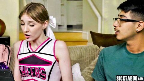 Melody Marks in cheerleader outfit with shy glasses-wearing friend, teasing on couch