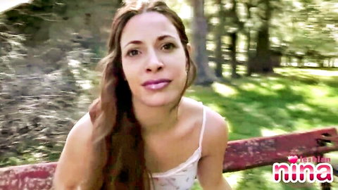 Nina's outdoor lesbian striptease on bench, natural tits tease