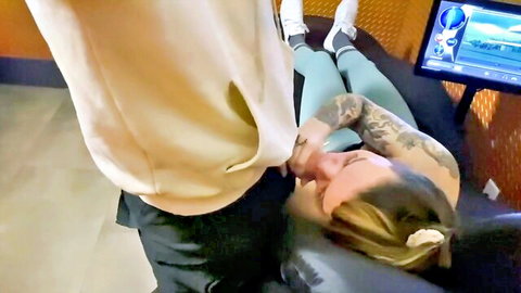 Tattooed fit brunette lies topless on gym massage table as man gropes her big exposed tits