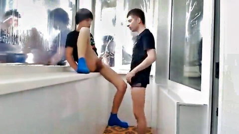 Gay twink with bare ass exposed on windowsill groped by buddy in shorts