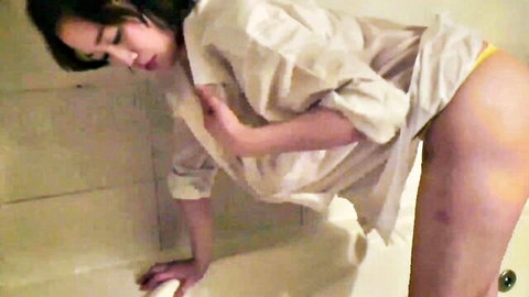 Korean brunette bends over bathtub in open white shirt and yellow panties showing big ass and side tits