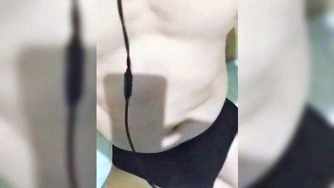 Amateur solo male in black underwear showing abs and headphones