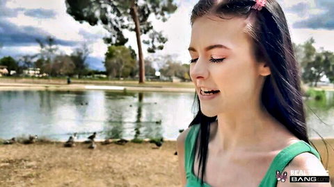 Brunette teen Ella Nova in green tank top by pond outdoors