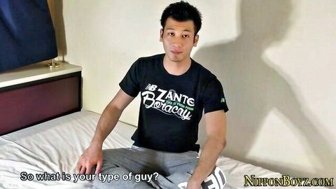 Macho Chinese guy in t-shirt and sweats sitting on bed, solo tease