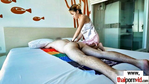 Thai masseuse in lingerie gives erotic massage to nude man on bed