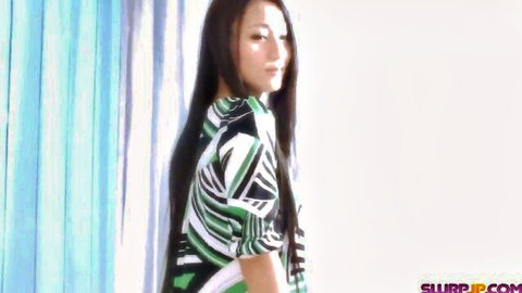 Sexy Asian brunette with long hair posing sideways in green patterned blouse