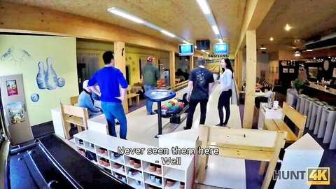 Dark-haired woman strokes stranger's cock in public bowling alley before boyfriend