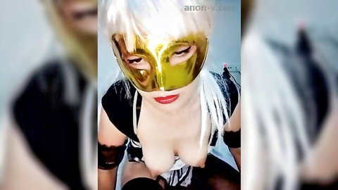 Gold-masked blonde in sexy maid outfit teasing with huge tits and deep cleavage