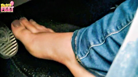 Sexy barefoot teen foot pressing car accelerator pedal in tight jeans foot fetish tease
