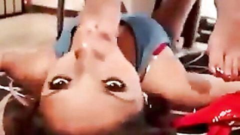 Lesbian foot slave used upside down in red high heels and blue top