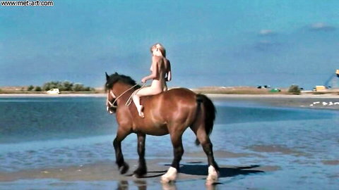 Mila I topless in tiny bikini riding horse on sunny beach