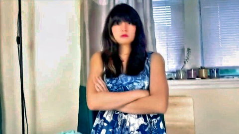 Step-mom Melissa in blue dress, arms crossed, giving stern JOI