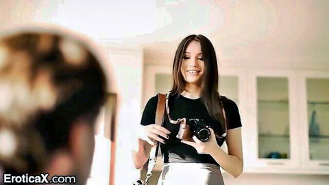 Liv Wild as sexy photographer smiling with camera in tank top and skirt