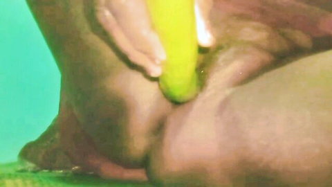 Dark-skinned man's tight asshole penetrated by thick yellow banana underwater