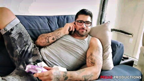 Tattooed muscular man in tank top on couch, Vanessa adult clip