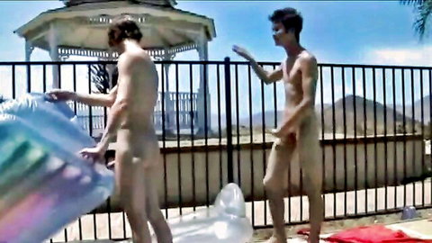 Two athletic nude men by the pool, ready for outdoor gay fun