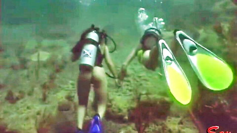 Two sexy scuba babes diving underwater with bare wet asses exposed