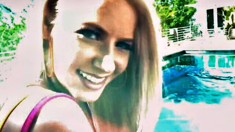 Smiling blonde bombshell in pink top by outdoor pool, daring adventure tease