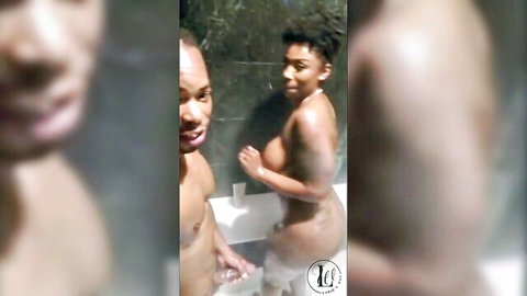 Nude ebony couple with big tits smiling in steamy shower bath