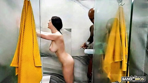 Nude curvy Asian woman bending in steamy shower with black man behind her
