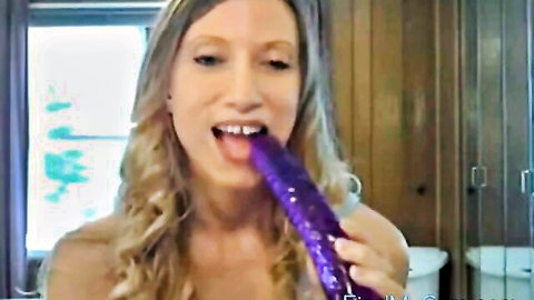 Blonde woman deepthroating massive purple dildo, teasing anal play