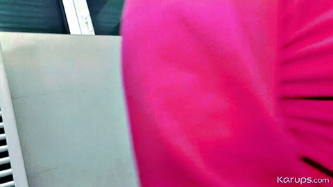 Woman's tight pink dress pressed against white bedroom blinds closeup
